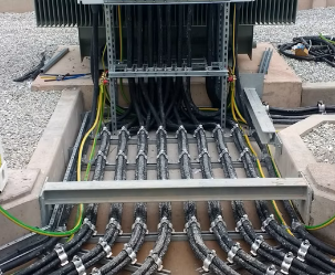 the cables of an electrical substation transformer in the process of being installed, the cables are neatly routed.