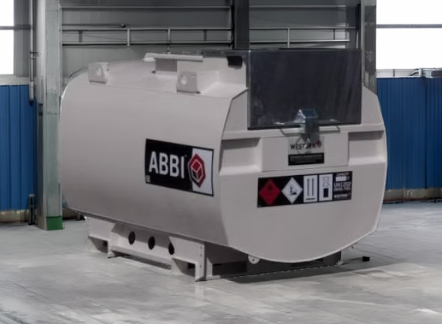 A white fuel storage tank, which is shaped like a cylinder, on the front it has the 'Western' logo on it with warning labels under it, and on the side it has the name of the product 'Abbi' on it in white with a black square around it.