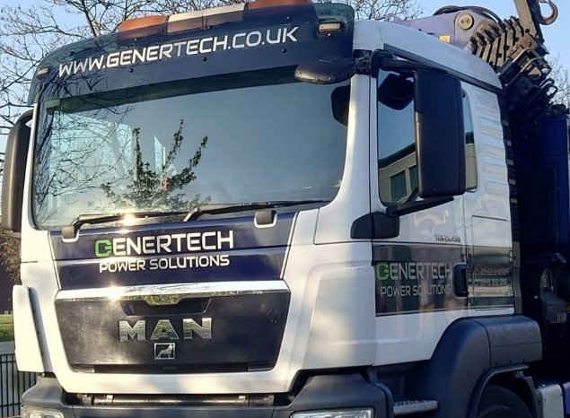 A white and black lorry that has the Genertech URL above the windscreen and the Genertech logo which has text that reads 'Genertech Power Solutions' on the front and on the doors.