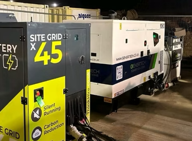 This is an image of a white Genertech diesel generator in use at a site.