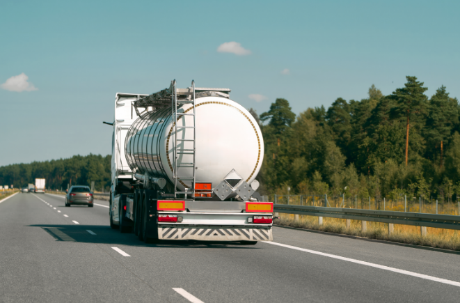 This is a stock image of a Lorry that's transporting a diesel tank, it's driving on a motorway.