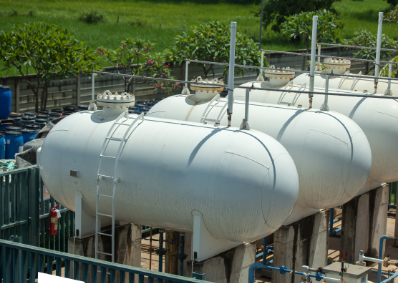 a stock image of 4 fuel tanks lined up together, they are white and cylindrical, two of them are partially out of frame.
