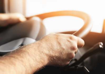 This is a stock image of a man gripping a steering wheel.